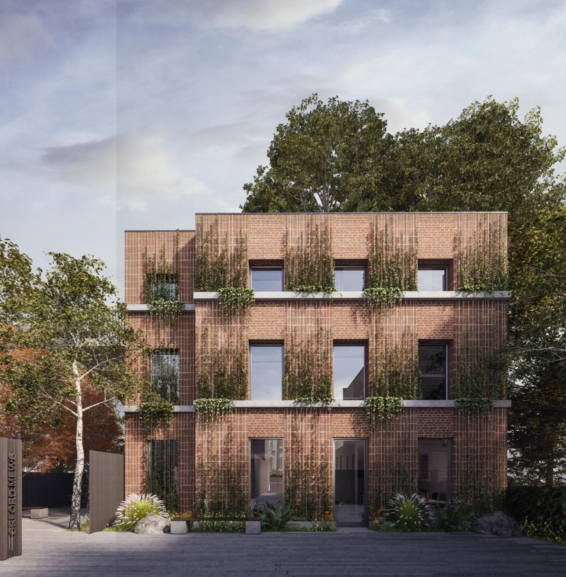 Modern brick residential building with sustainable design elements, featuring greenery, in East London’s Orford Mews development.
