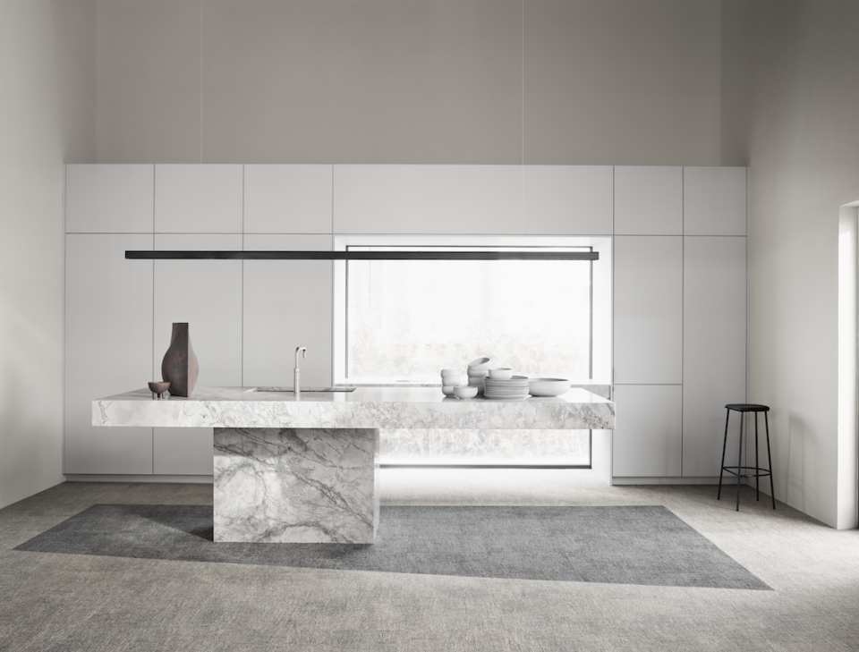 Sleek modern kitchen featuring Ege Carpets' ReForm collection, showcasing sustainable design and elegant marble island with stylish decor.