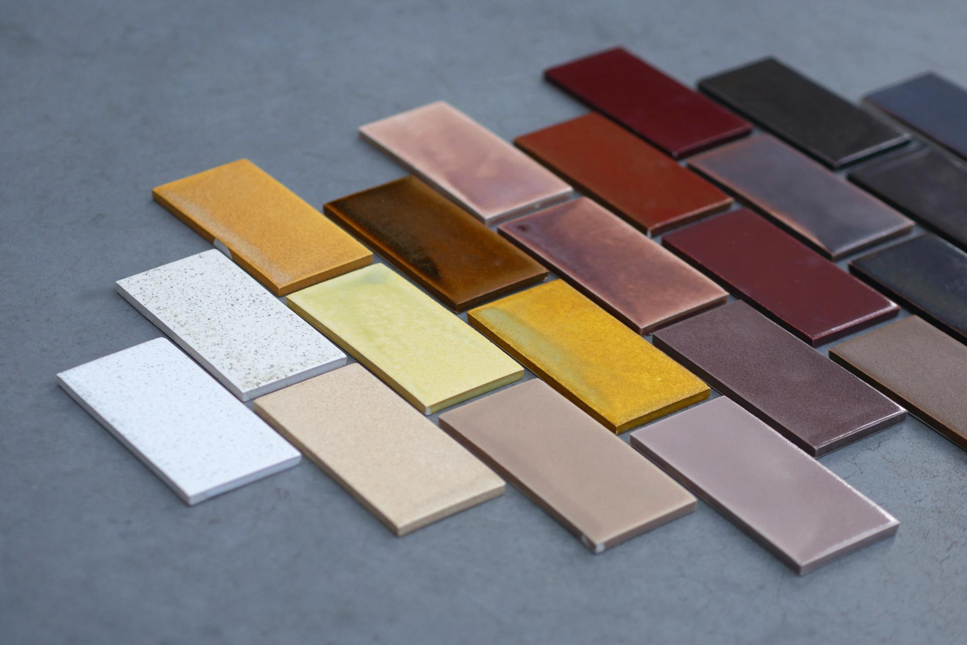 Colorful tiles made from sustainable biomaterials, showcasing various textures and shades for eco-friendly architectural design.