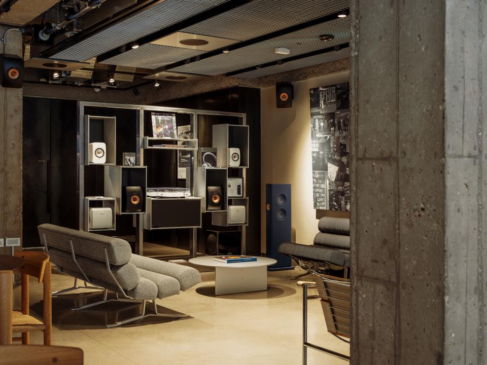 Modern interior of KEF Music Gallery London featuring high-end audio equipment and stylish seating areas.