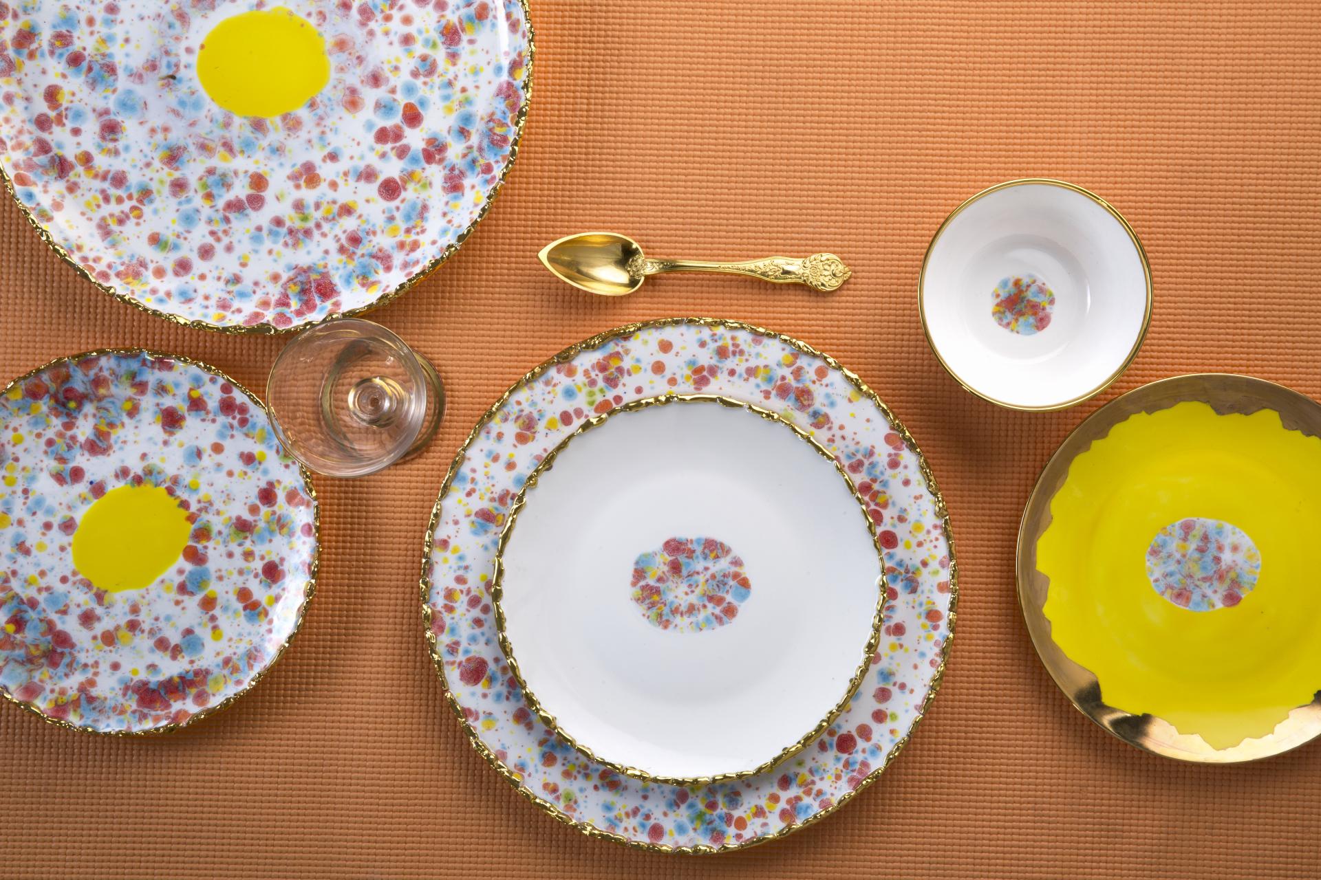 Colorful designer tableware featuring unique splatter patterns, reflecting Coralla Maiuri's experimental and sunny artistic style.