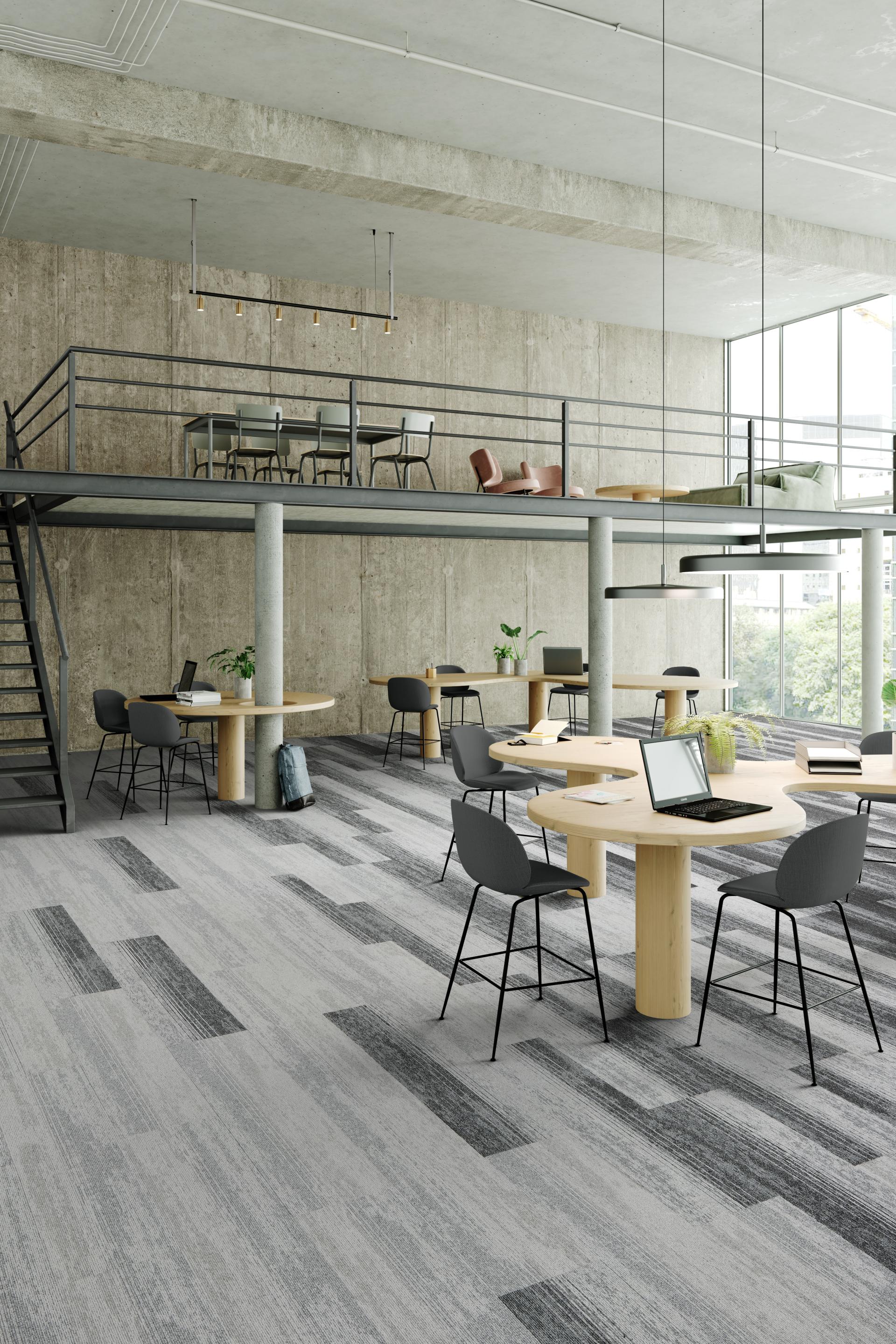 Modern workspace featuring IVC's Rudiments carpet tiles, designed for collaboration with stylish furniture and ample natural light.