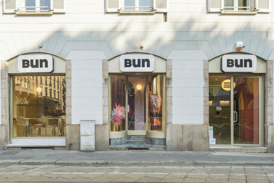 Stylish storefront of Bun restaurant in Milan’s Brera district, featuring modern signage and colorful decor elements.