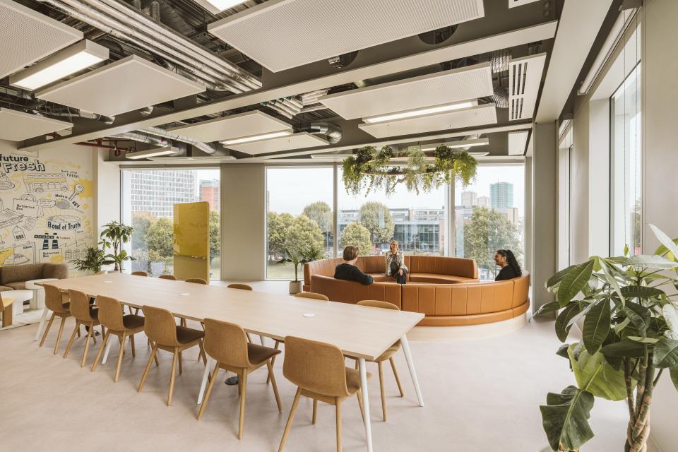 Modern workspace featuring a circular lounge area and a long table, designed for collaboration at Butternut Box.