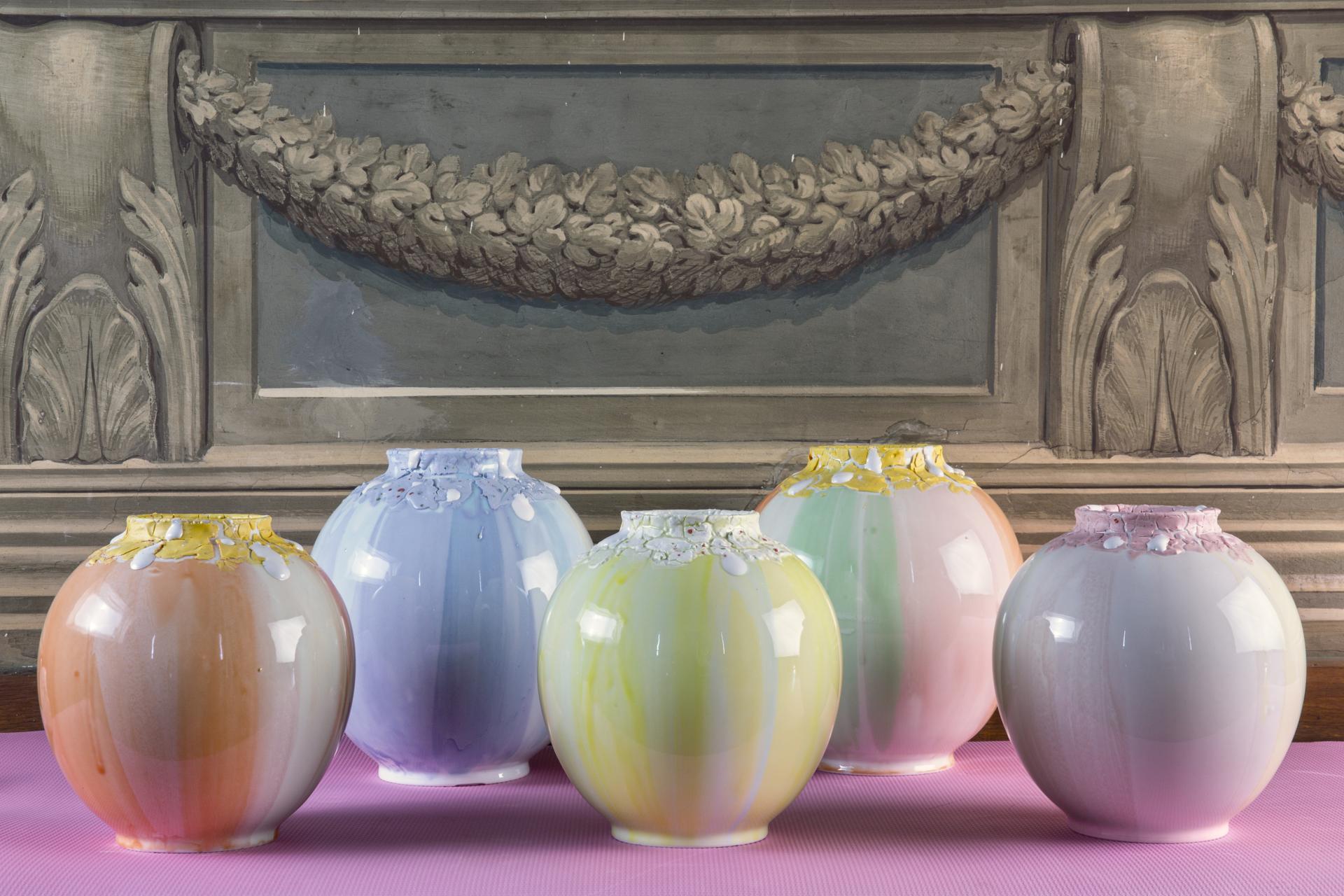 Colorful vases with unique textures displayed on a table, highlighting Coralla Maiuri's experimental and artistic design style.