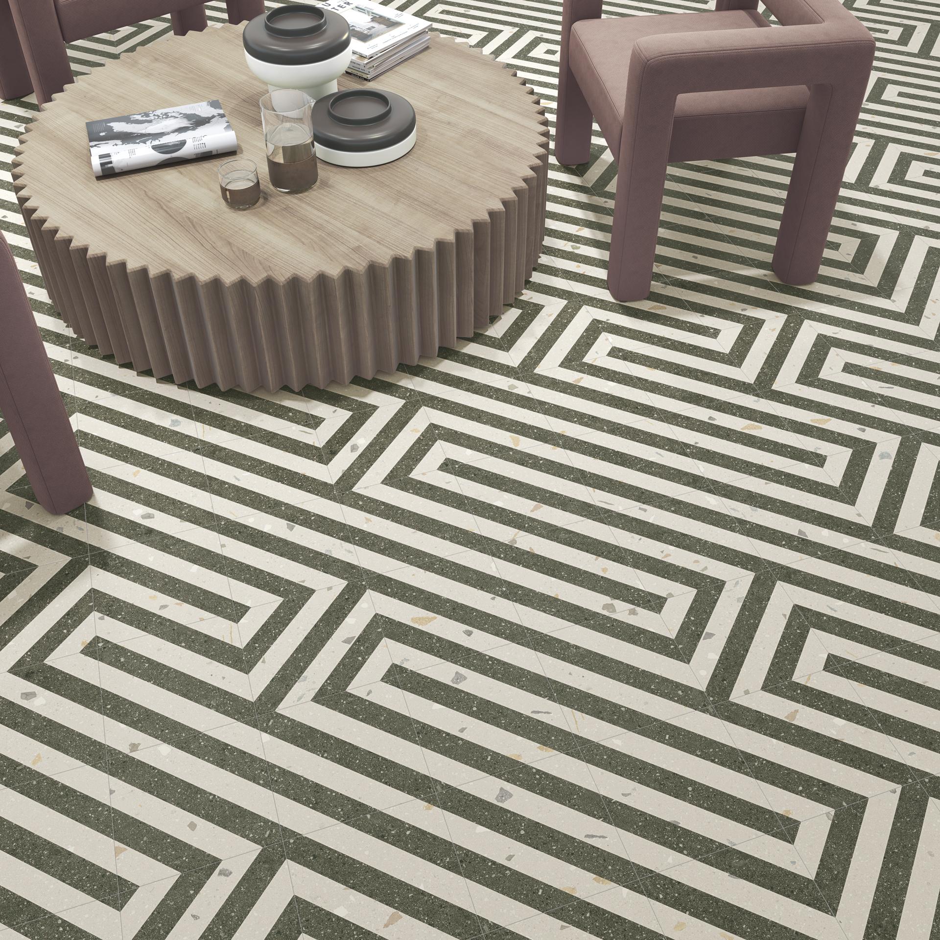 Stylish interior featuring geometric tile flooring, a round wooden table, and modern chairs, showcasing Cevisama 2023 trends.