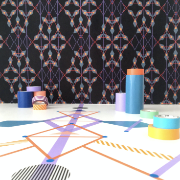 Colorful geometric patterns and decorative tape rolls on a surface, illustrating the concept of pattern as seen under a microscope.
