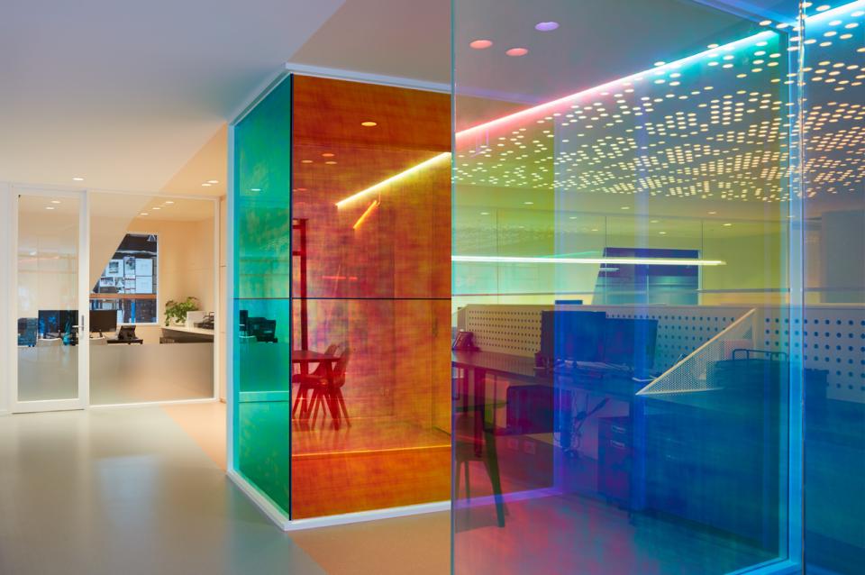 Vibrant office design featuring optical prisms that create colorful light effects in a modern workspace for Ambience.