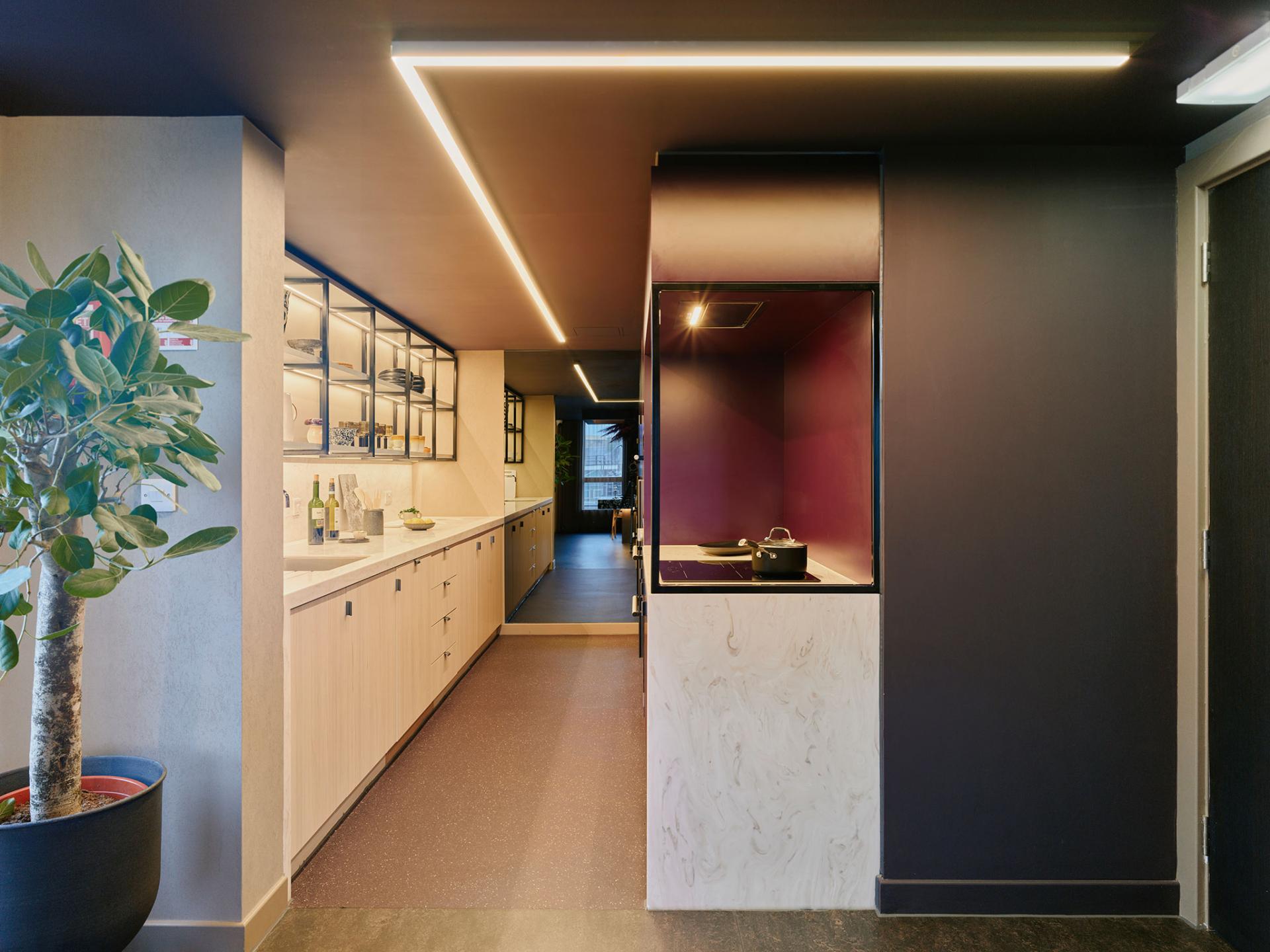 Modern interior design of a kitchen area in 16-18 Potterrow, featuring stylish cabinetry and ambient lighting.