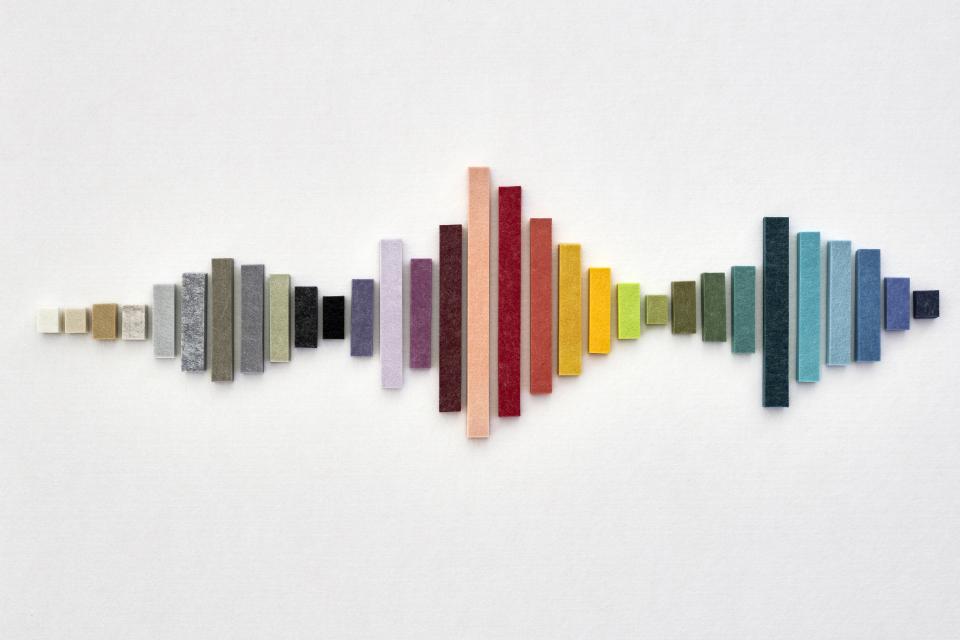 Colorful EchoPanel® acoustic samples arranged in a wave design, celebrating Woven Image's 15-year milestone.