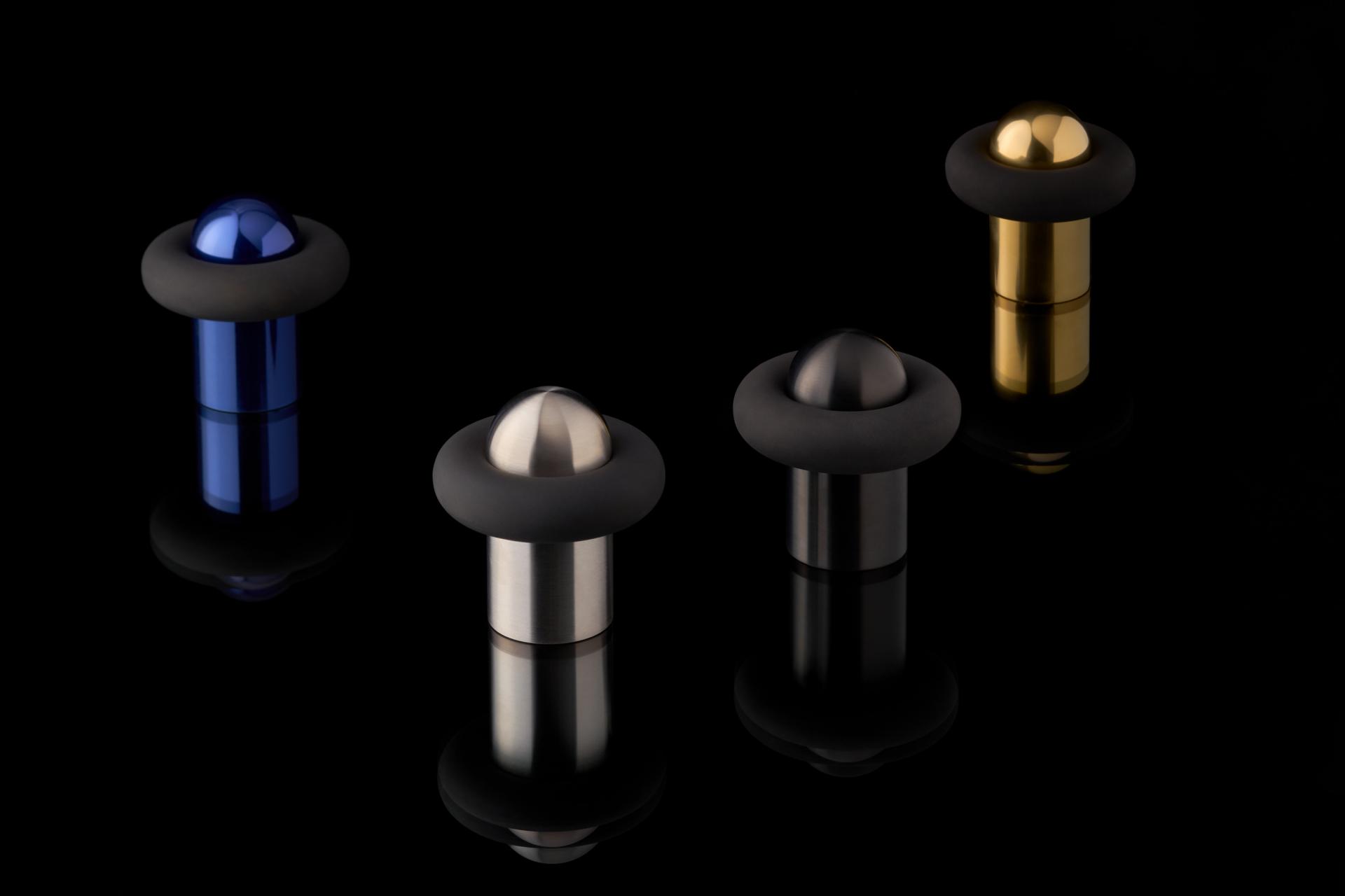 Colorful architectural ironmongery pieces from Tom Dixon's FAT collection, showcasing sleek designs and modern materials.