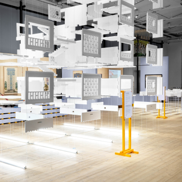 Hanging architectural models illustrate the evolution of concrete design in the ArkDes exhibition, showcasing post-war urban reconstruction.