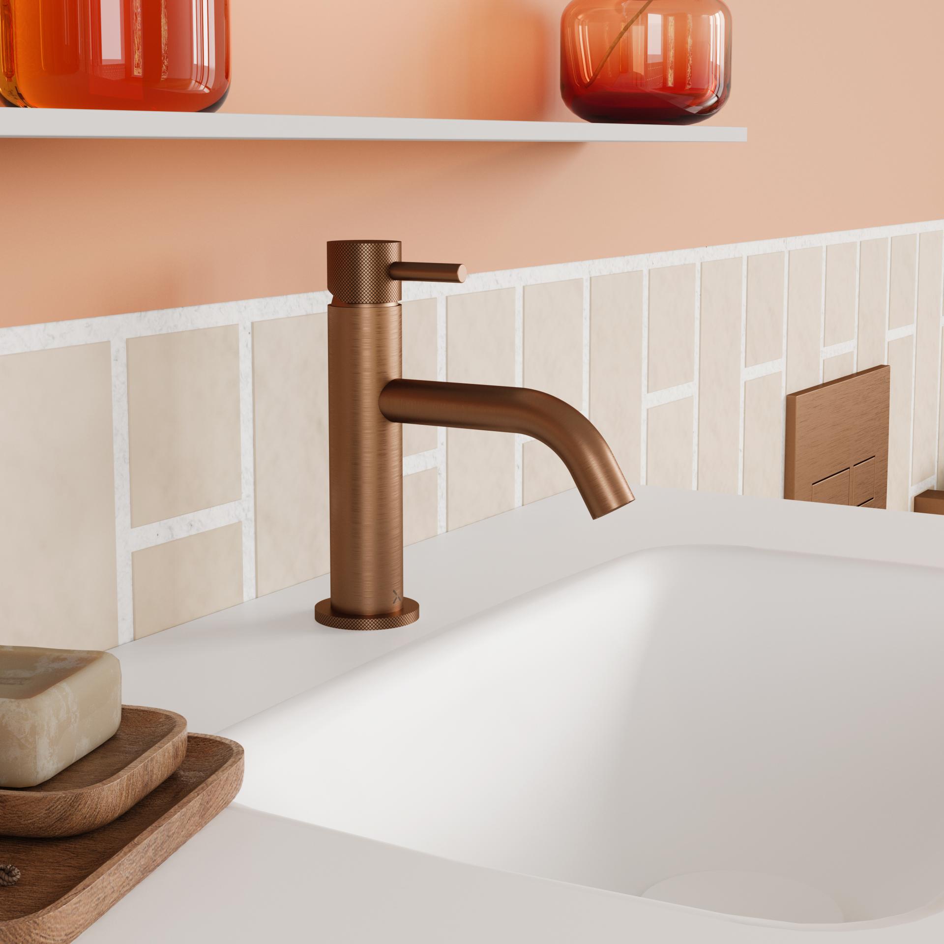 Sleek bronze faucet in a modern bathroom setting, featuring elegant tile backsplash and minimalist design elements.