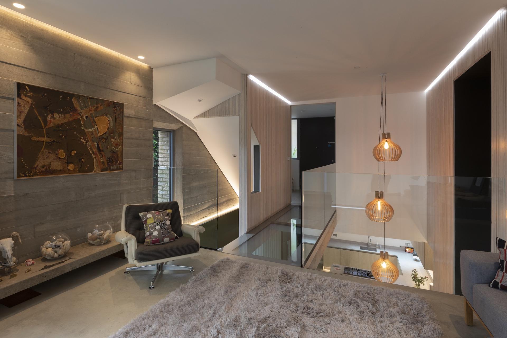 Modern interior featuring artistic lighting, sleek furniture, and a blend of textures, emphasizing the role of light in design.