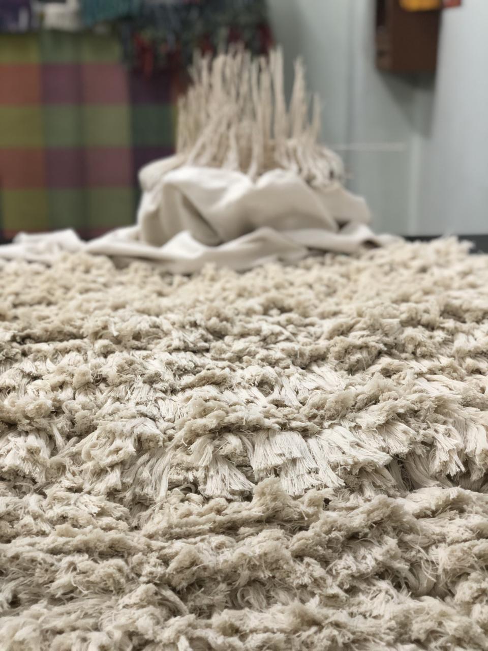 Textured, cream-colored tapestry made from cruelty-free ahimsa silk, showcasing Erez Nevi Pana's sustainable design approach.