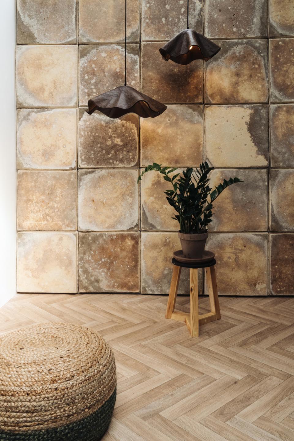 Stylish interior design featuring sustainable decor, including pendant lights, a potted plant, and eco-friendly materials.