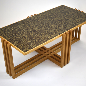 Contemporary wooden dining table designed by Laurent Peacock, featuring a unique textured black surface, showcased at London Craft Week 2020.