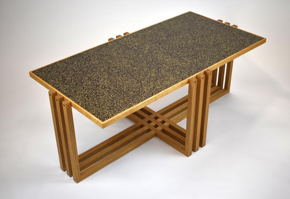 Contemporary wooden dining table designed by Laurent Peacock, featuring a unique textured black surface, showcased at London Craft Week 2020.
