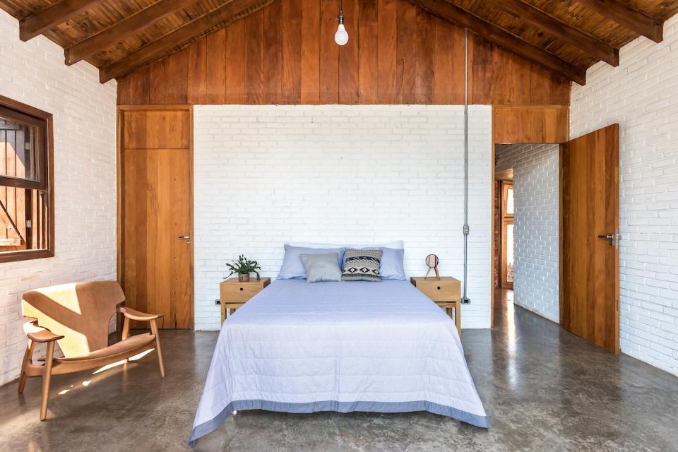 Modern bedroom in The Lake House, featuring natural wood accents, minimalist decor, and tranquil ambiance.