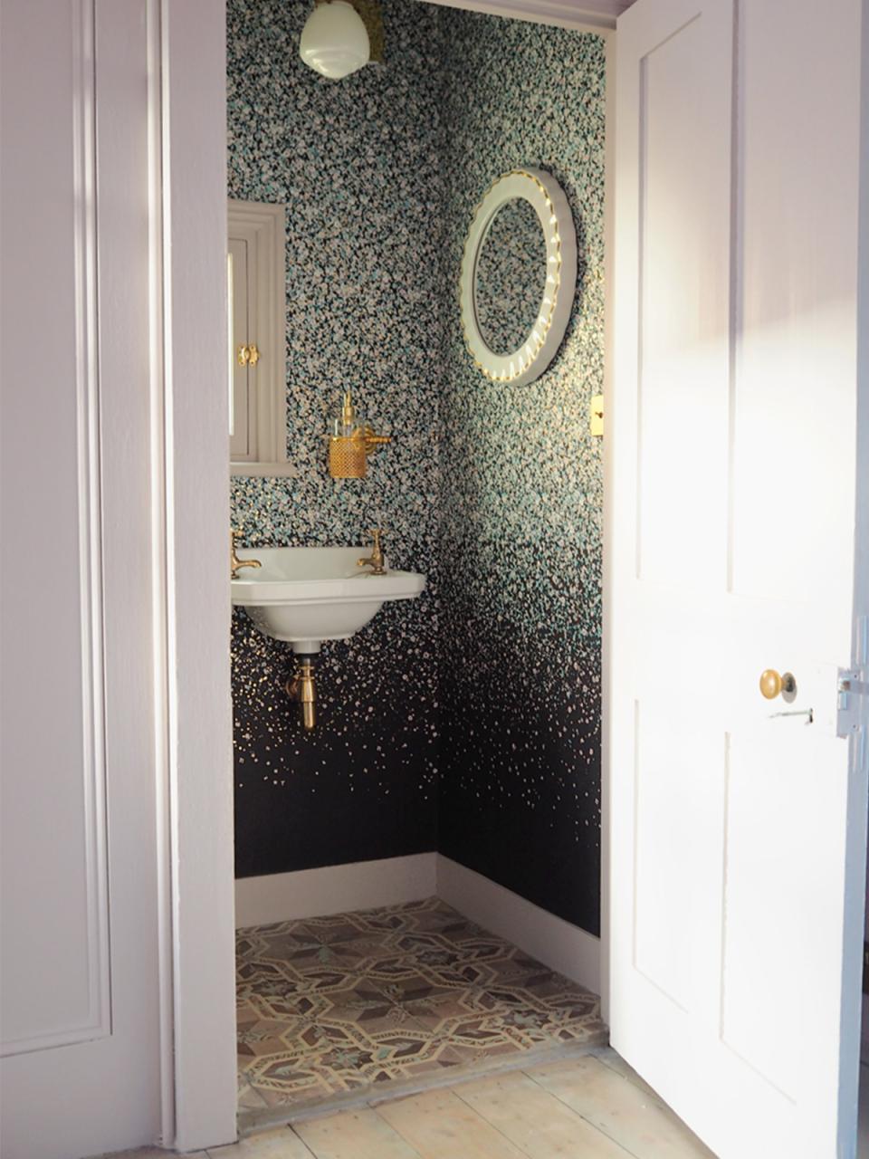 Elegant bathroom featuring floral patterned wallpaper, vintage sink, and unique tile flooring, designed by 2LG Studio.