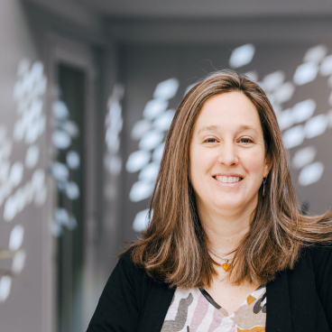 Professor Jaime Toney smiles in an office setting, highlighting the Centre for Sustainable Solutions at the University of Glasgow.