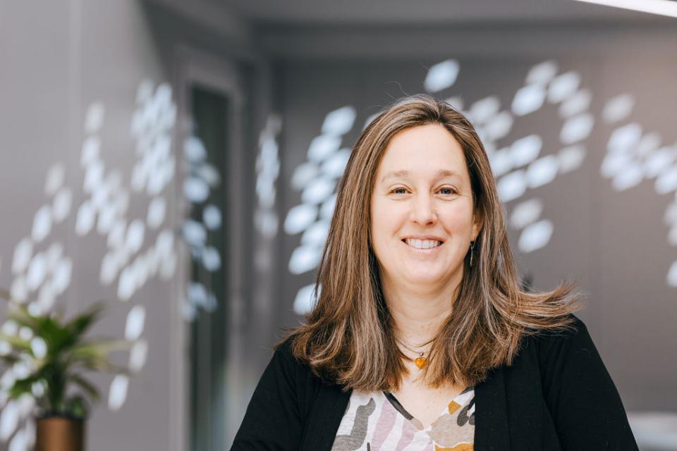 Professor Jaime Toney smiles in an office setting, highlighting the Centre for Sustainable Solutions at the University of Glasgow.