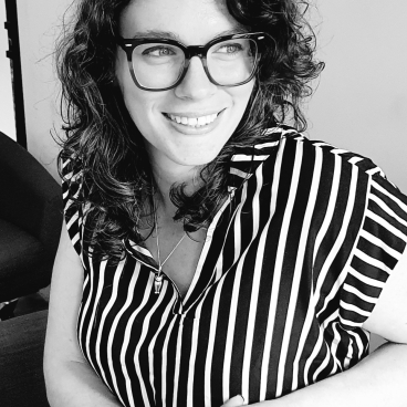 Charlotte Thornton, an interior designer at jmarchitects, smiling while discussing sustainable design and uplifting color palettes.