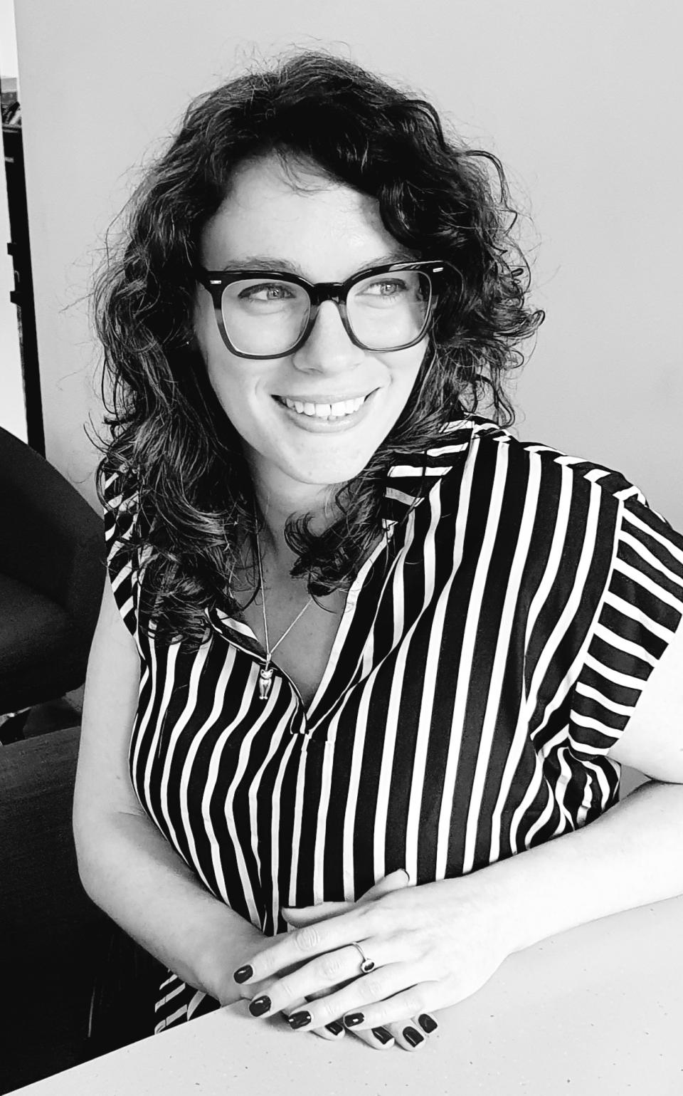 Charlotte Thornton, an interior designer at jmarchitects, smiling while discussing sustainable design and uplifting color palettes.