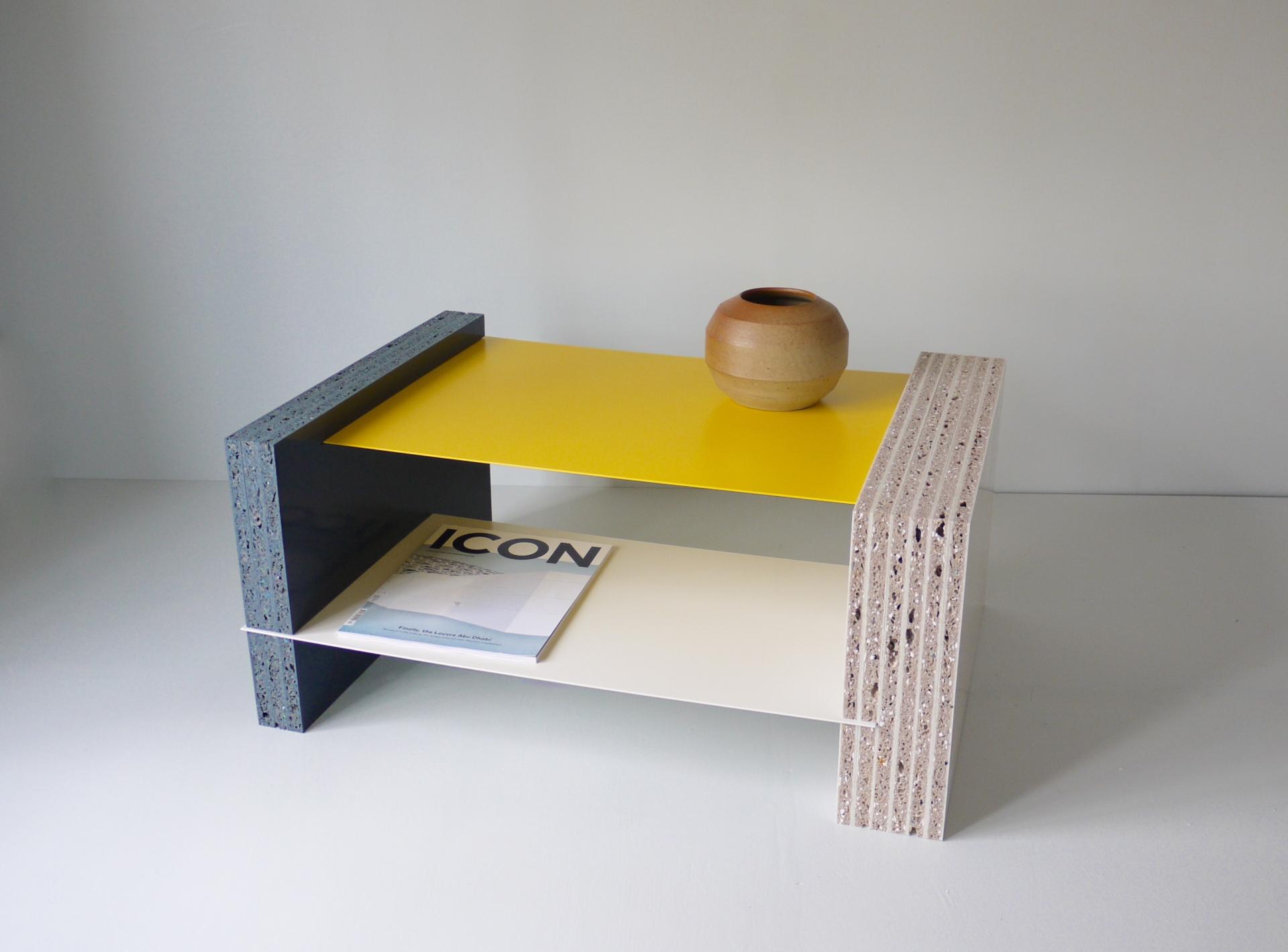Colorful coffee table made from 100% recycled plastic, featuring a yellow top and natural wooden vase on display.