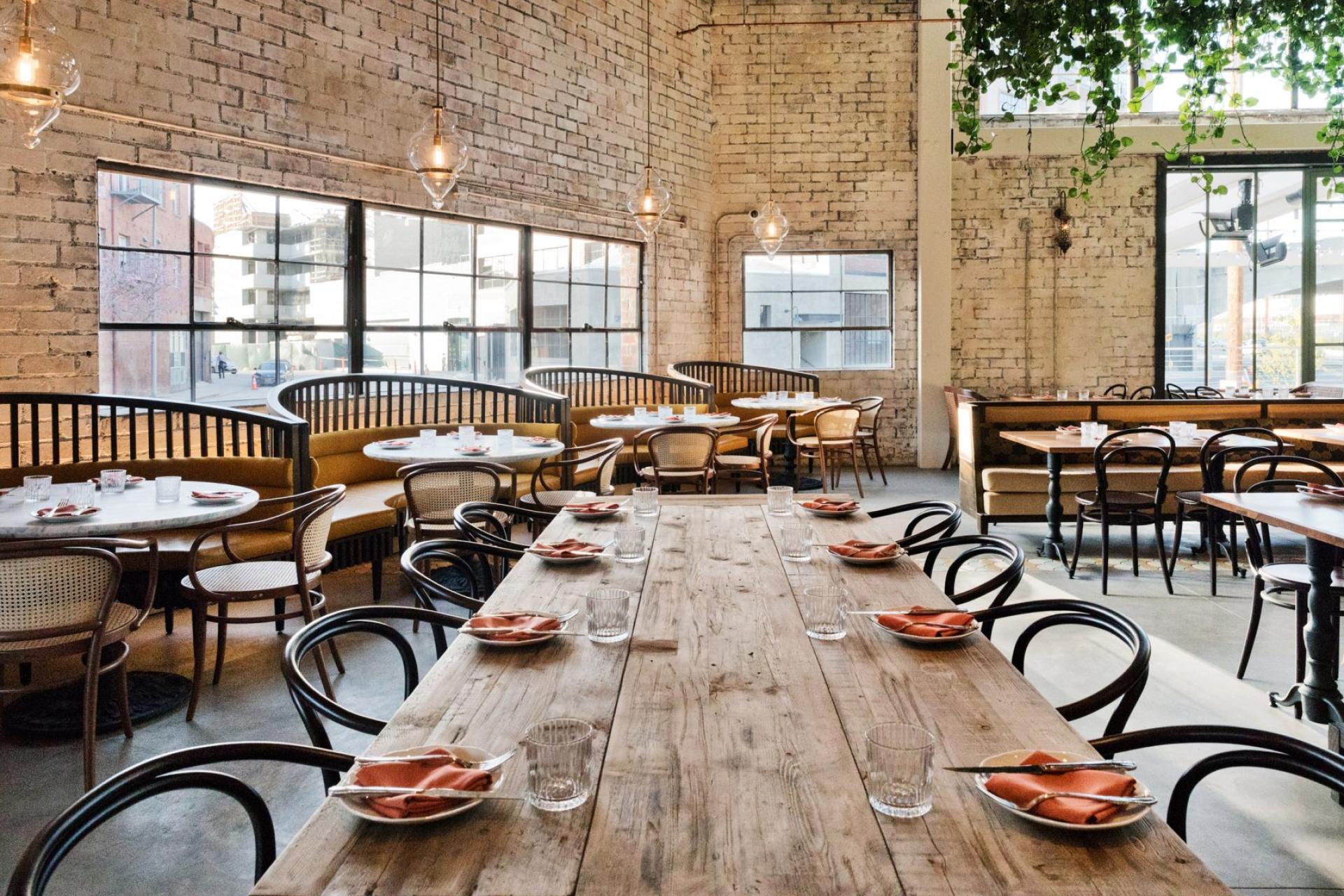 Contemporary restaurant interior by Studio Unltd featuring Moroccan-inspired design elements, rustic wooden tables, and stylish seating.