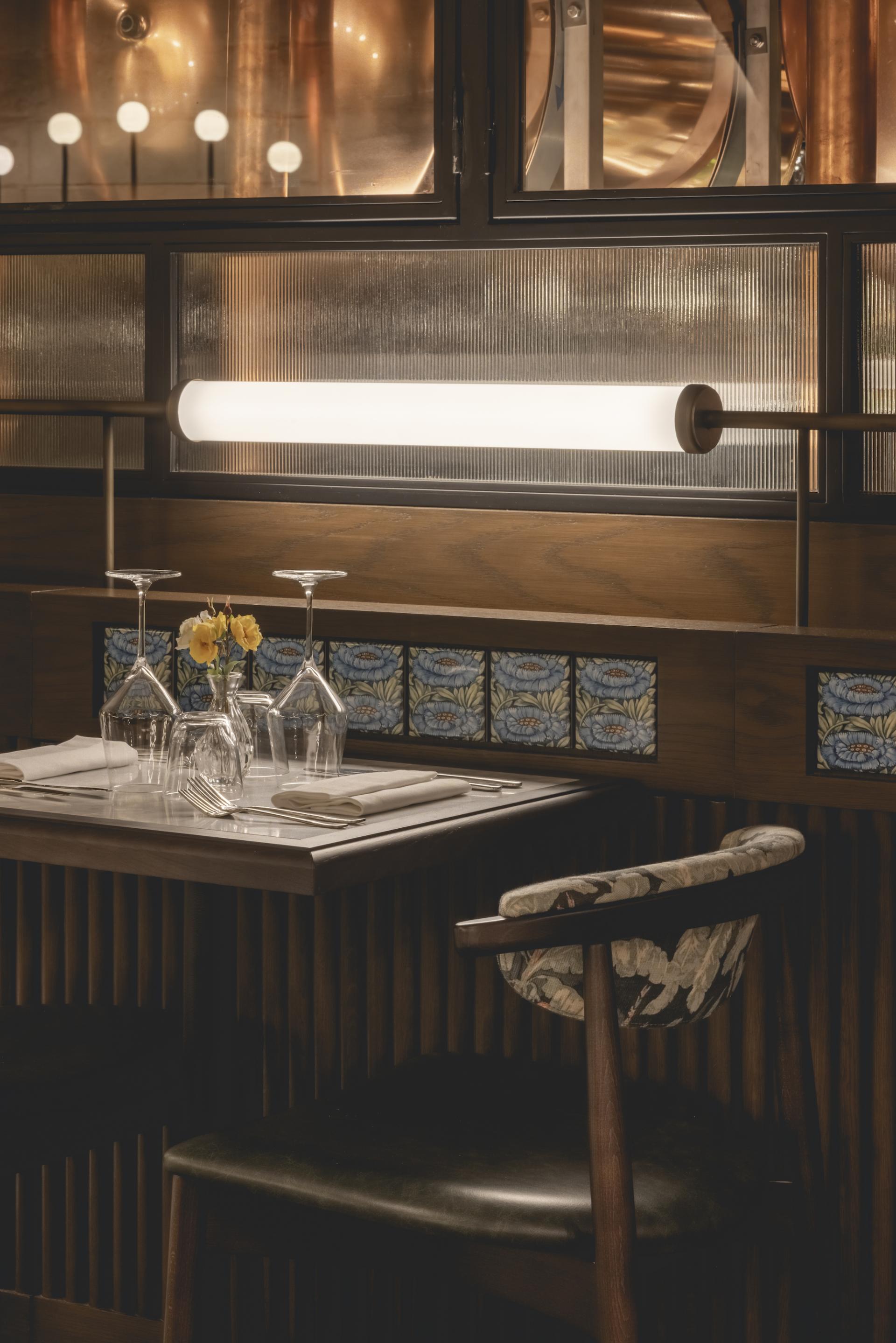Elegant dining table setup at The Libertine, showcasing glassware, floral décor, and stylish interior design in London’s Royal Exchange.