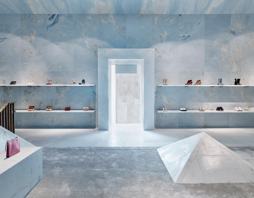 Céline's Miami store features blue marble walls, pyramid shapes, and stylish footwear displays in a modern design.