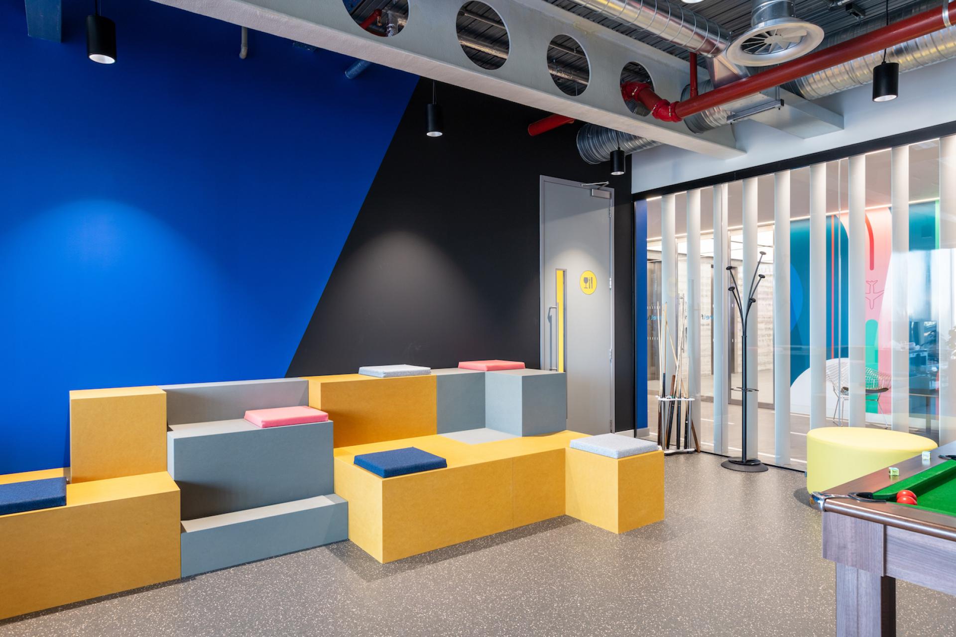 Stylish office lounge featuring colorful seating and contemporary design elements by Modus for Travelfusion's headquarters.