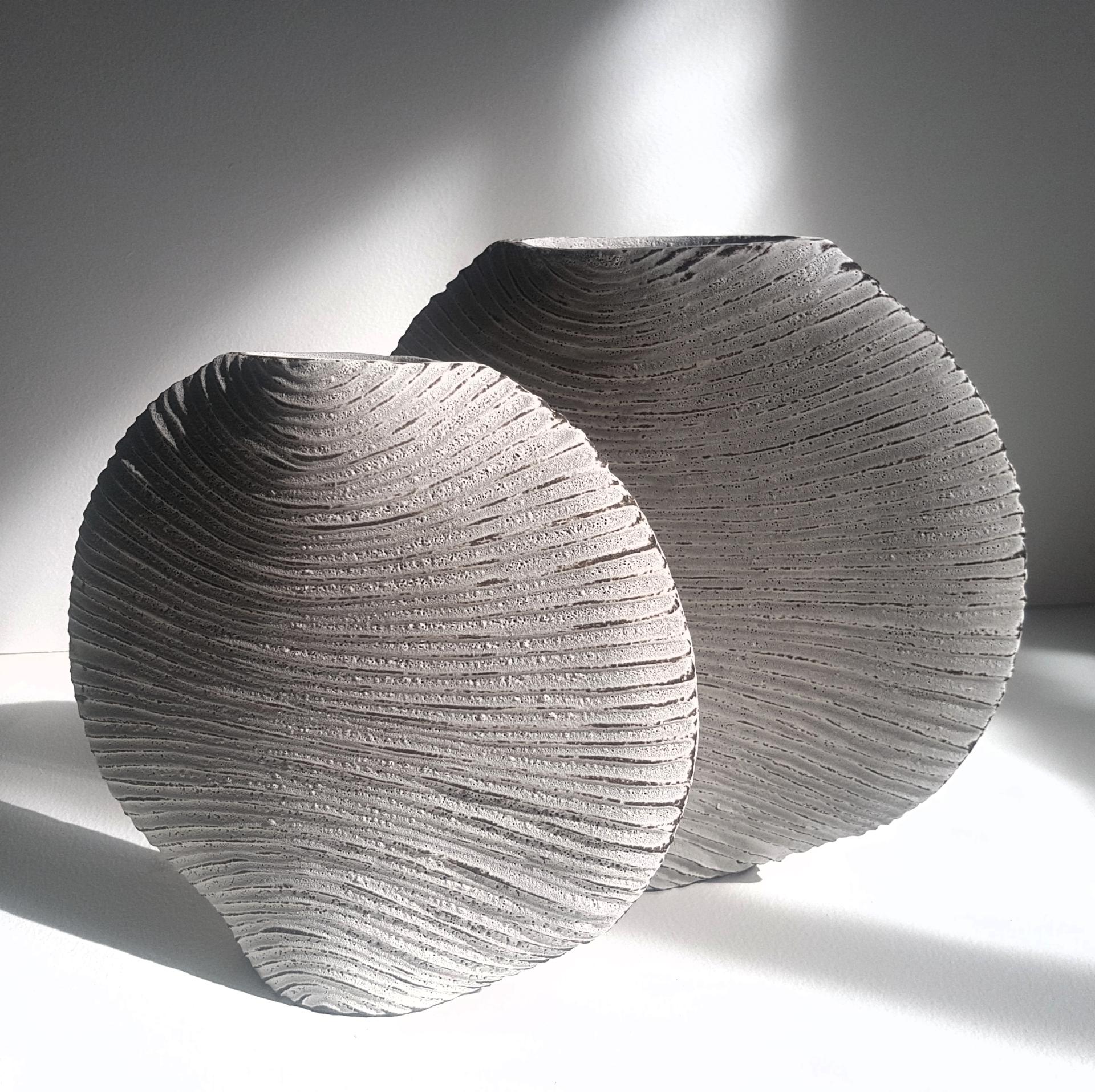 Textured grey ceramic vases, inspired by natural forms, showcasing Michele Bianco's craftsmanship and connection to the Scottish Highlands.