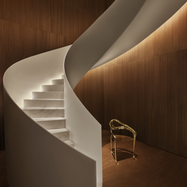 Stylish spiral staircase with illuminated steps in the Barcelona EDITION suite, showcasing modern design elements and luxurious ambiance.