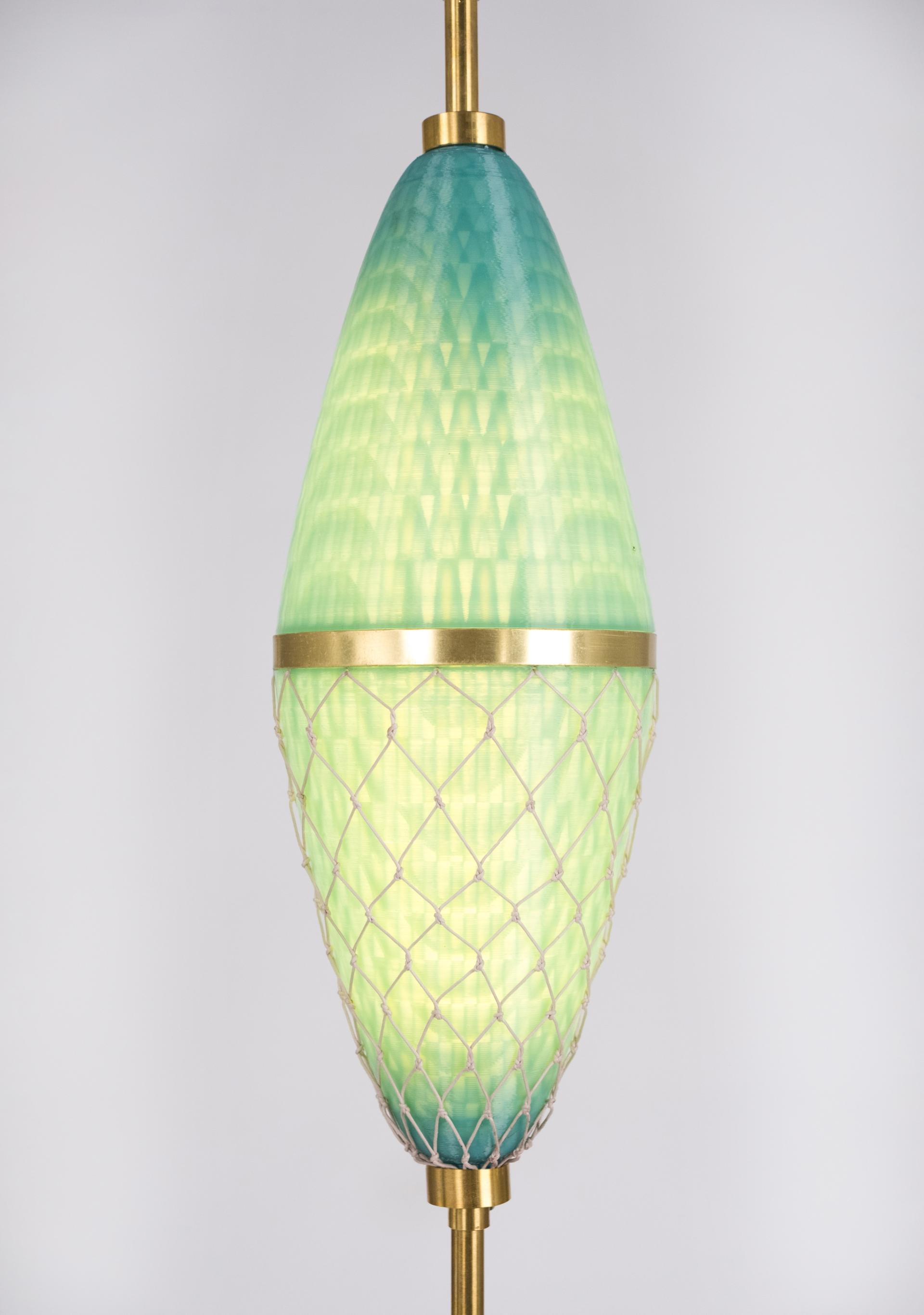 Sculptural pendant lamp featuring gradient green glass and a brass accent, showcasing modern design with heritage craftsmanship.