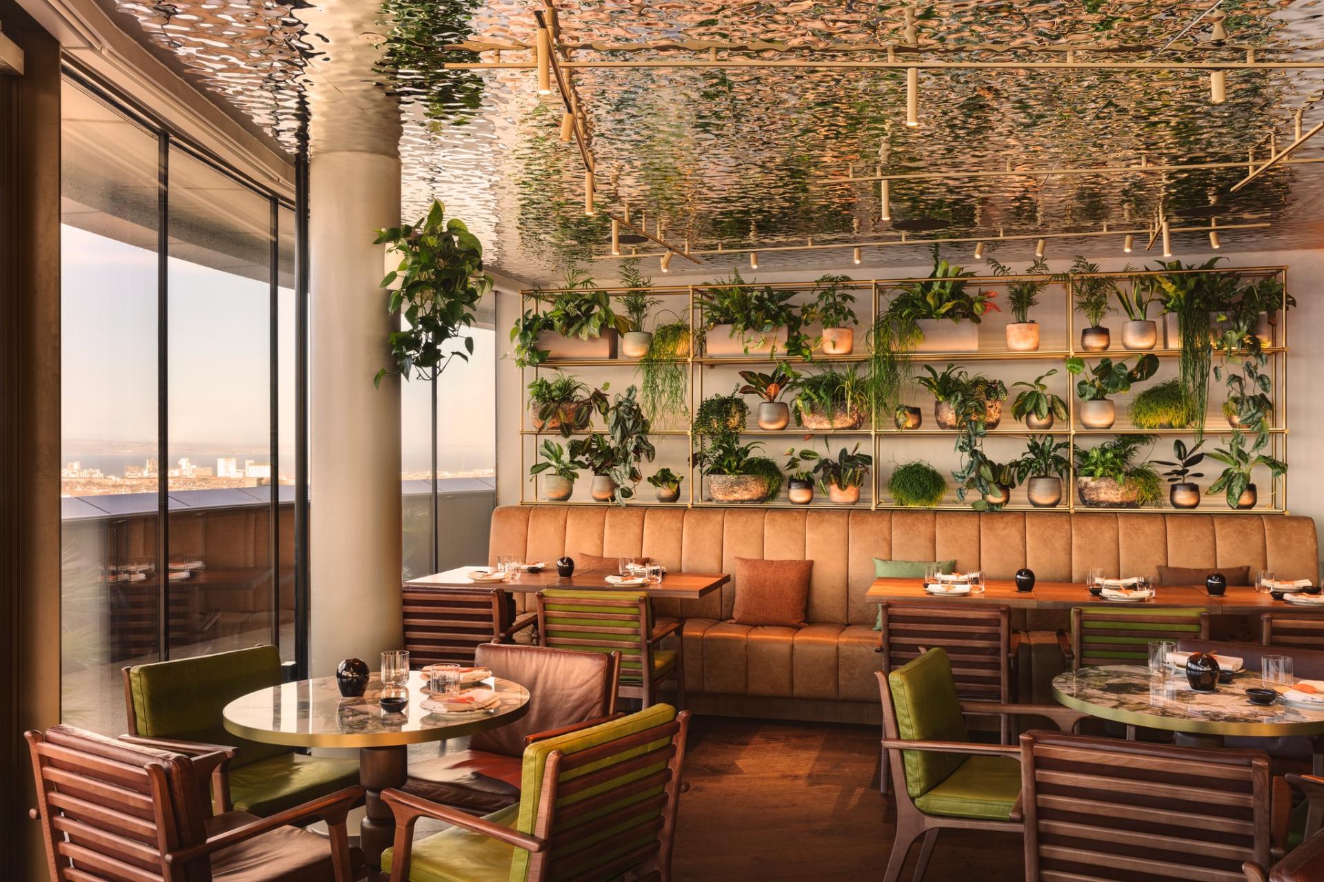 Stylish restaurant interior at W Hotel Edinburgh featuring lush botanical displays and modern decor, highlighting botanical transformation.