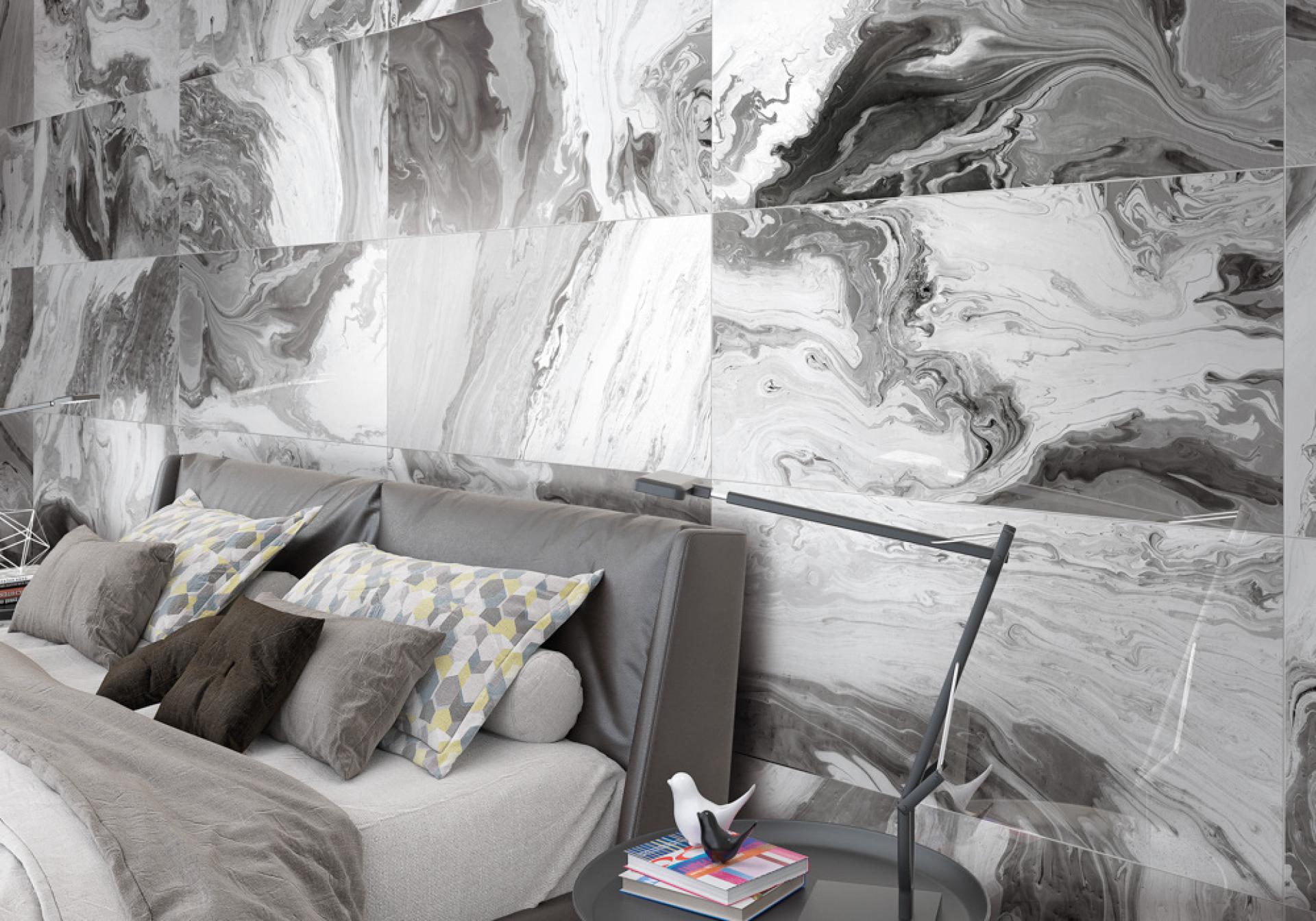 Luxurious bedroom featuring a marbled gray tile accent wall, stylish bedding, and modern decor elements.