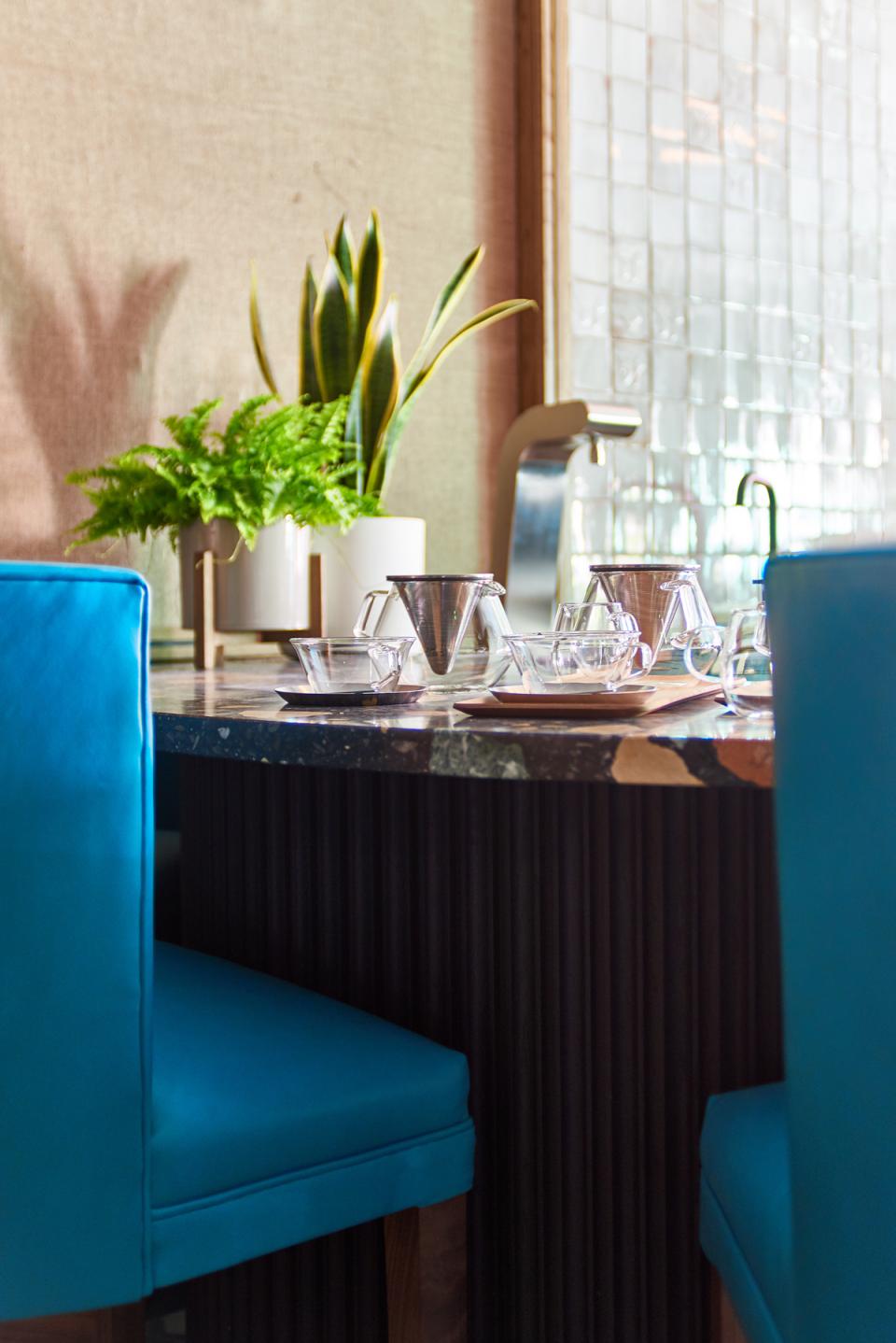 Stylish Art Deco-inspired seating and tea serving setup at Teatulia's tea shop and cocktail bar designed by Russell Sage Studios.