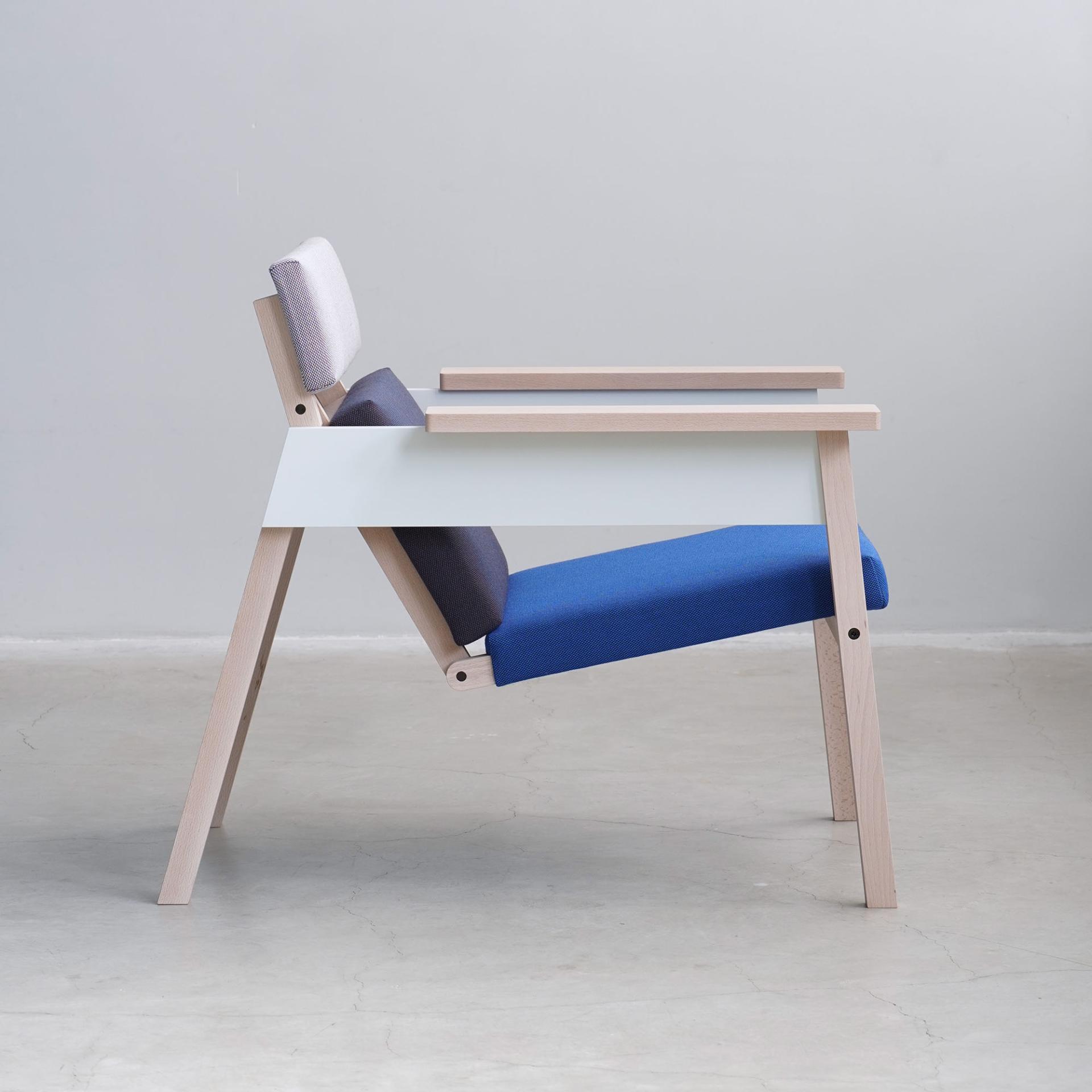 Modern chair design featuring layered cushions in contrasting colors, highlighting innovative sustainable furniture trends at the design event.