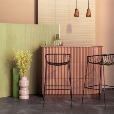 Contemporary bar setting featuring Tim Rundle's furniture designs, with colorful cabinetry and stylish black chairs.