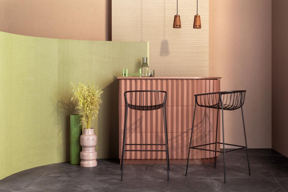 Contemporary bar setting featuring Tim Rundle's furniture designs, with colorful cabinetry and stylish black chairs.