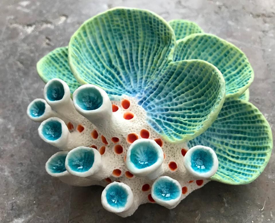 Brightly colored clay coral sculpture by Aardman Animations artist, showcasing intricate textures and ocean-inspired designs.