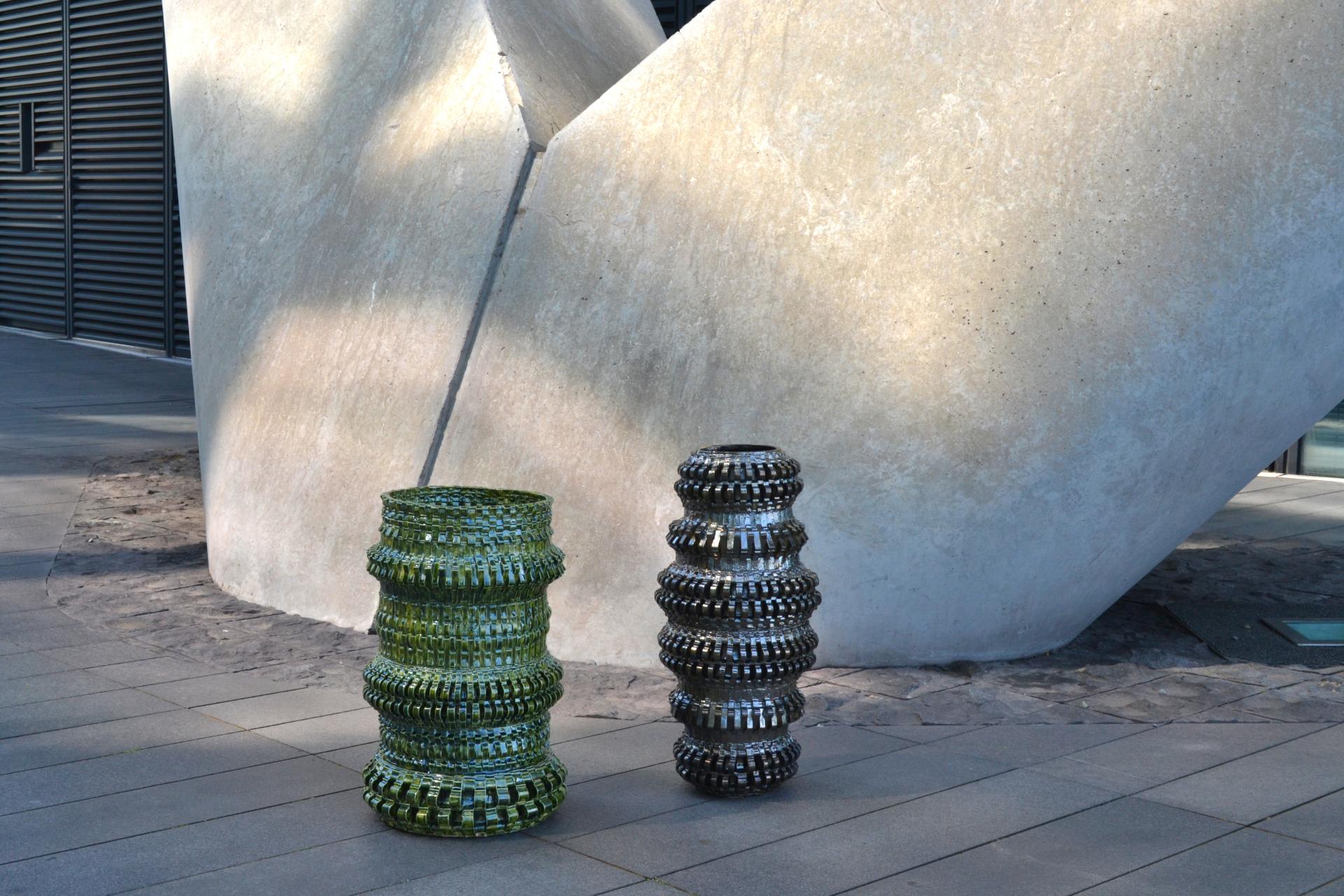 Colorful textile-inspired sculptural furniture pieces by Freyja Dorren, set against a modern architectural backdrop in Manchester.