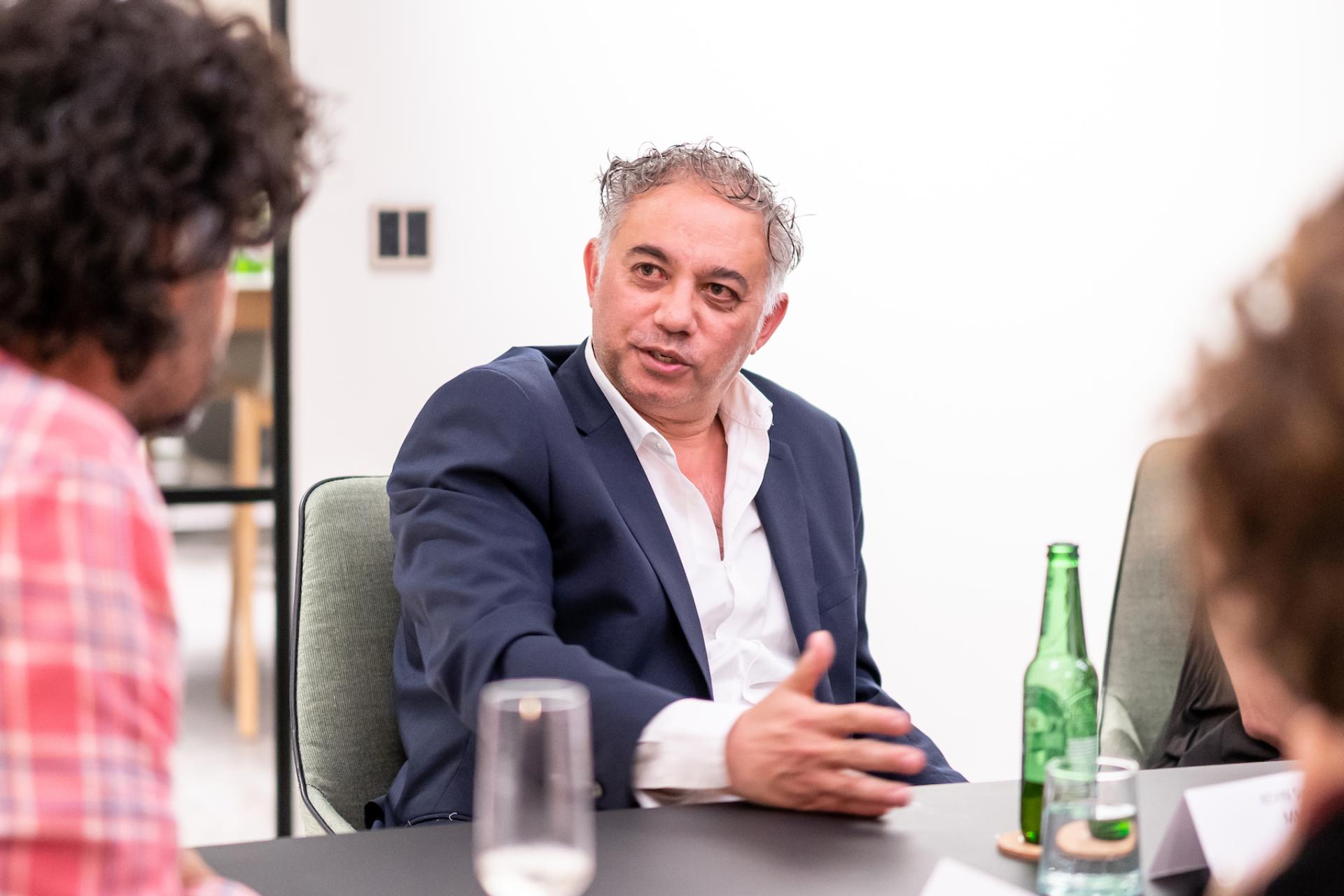 Business professionals engaged in a discussion about the future of education during a meeting.