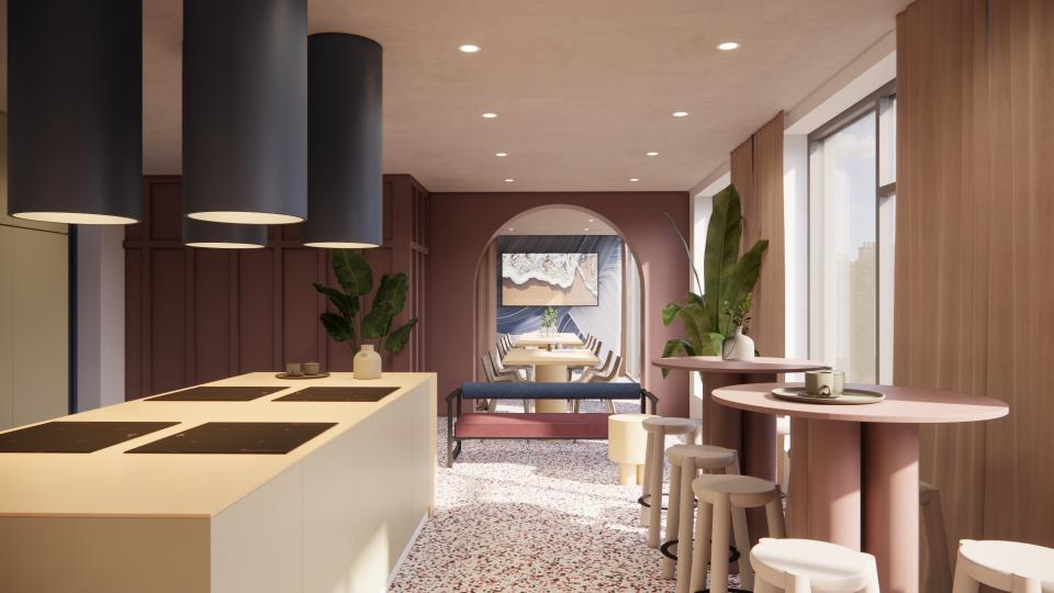 Modern co-living space designed by MONIKA Studio featuring a stylish kitchen and communal dining area with vibrant decor.