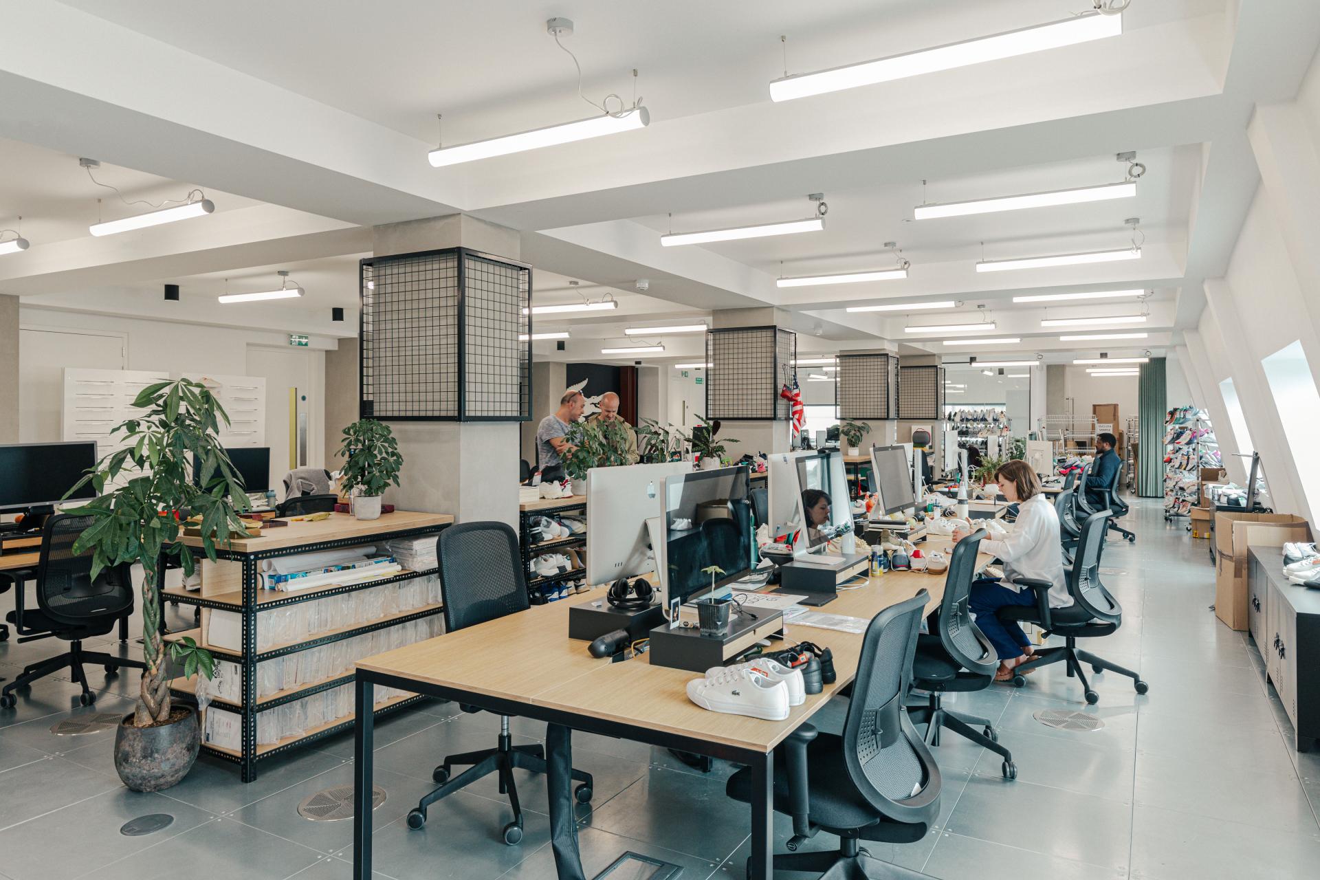 Contemporary office workspace for Lacoste, featuring modern design elements and a vibrant, collaborative atmosphere.