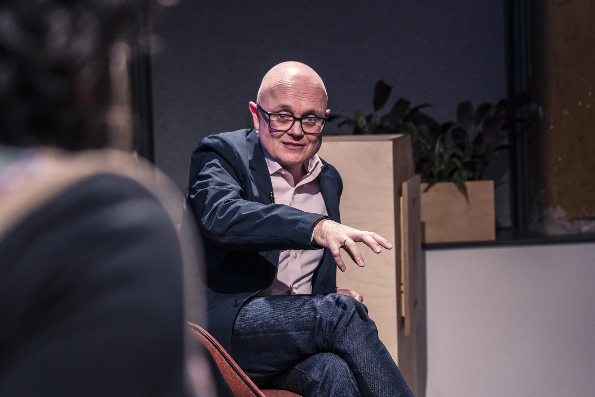 Engaging speaker at the Material Source Studio seminar discusses sustainability, fostering trust and action in the audience.