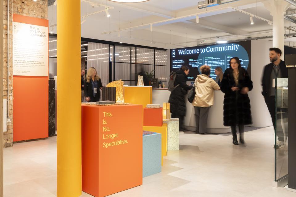 Vibrant interior of Material Source Studio, featuring colorful displays, visitors engaging, and a welcoming community atmosphere for creative events.