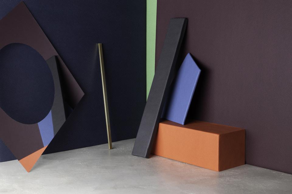 Textured, breathable performance textiles in various colors, inspired by Bauhaus design aesthetics, displayed in a modern setting.